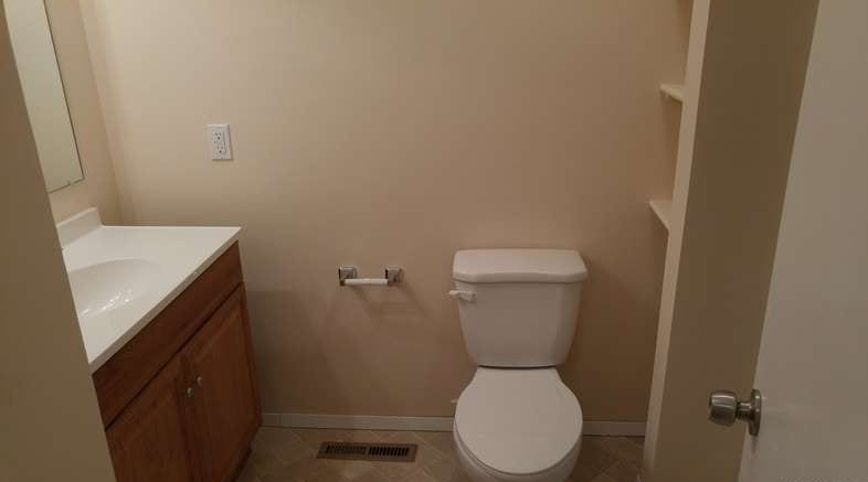 After: a modern bathroom, with new tile and a fresh coat of paint