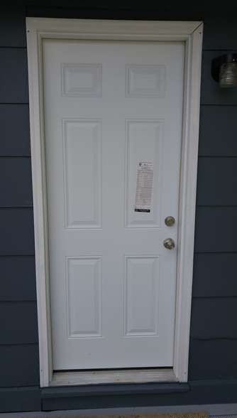 After: a new door with new siding