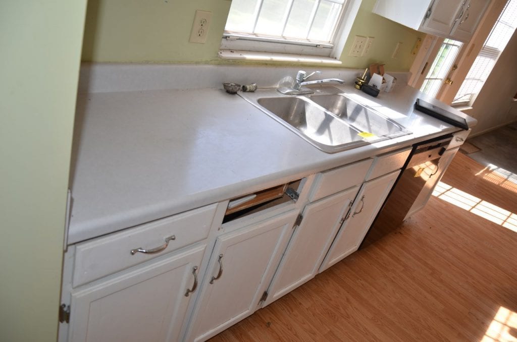 Before: a kitchen with older countertops and fixtures