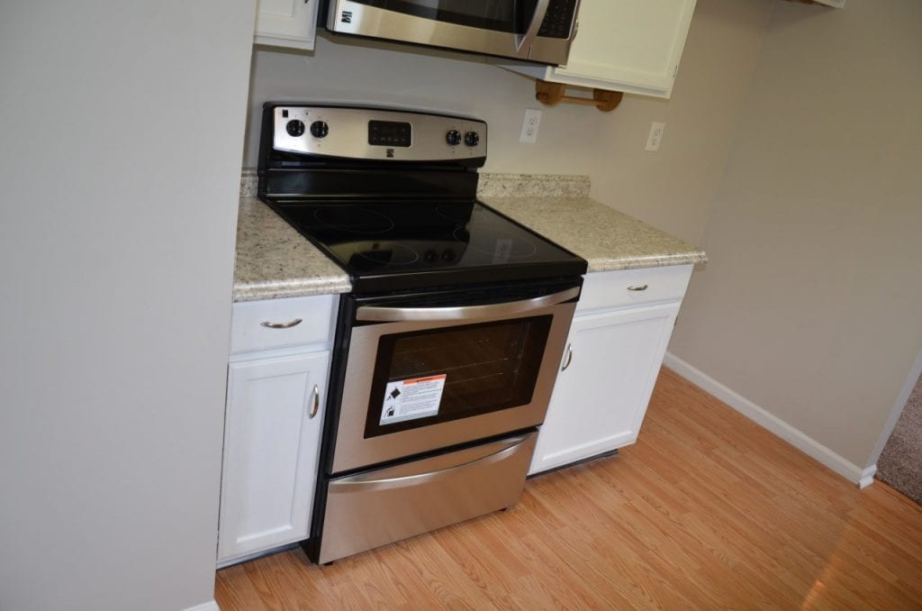 After: a kitchen with a new stove and microwave