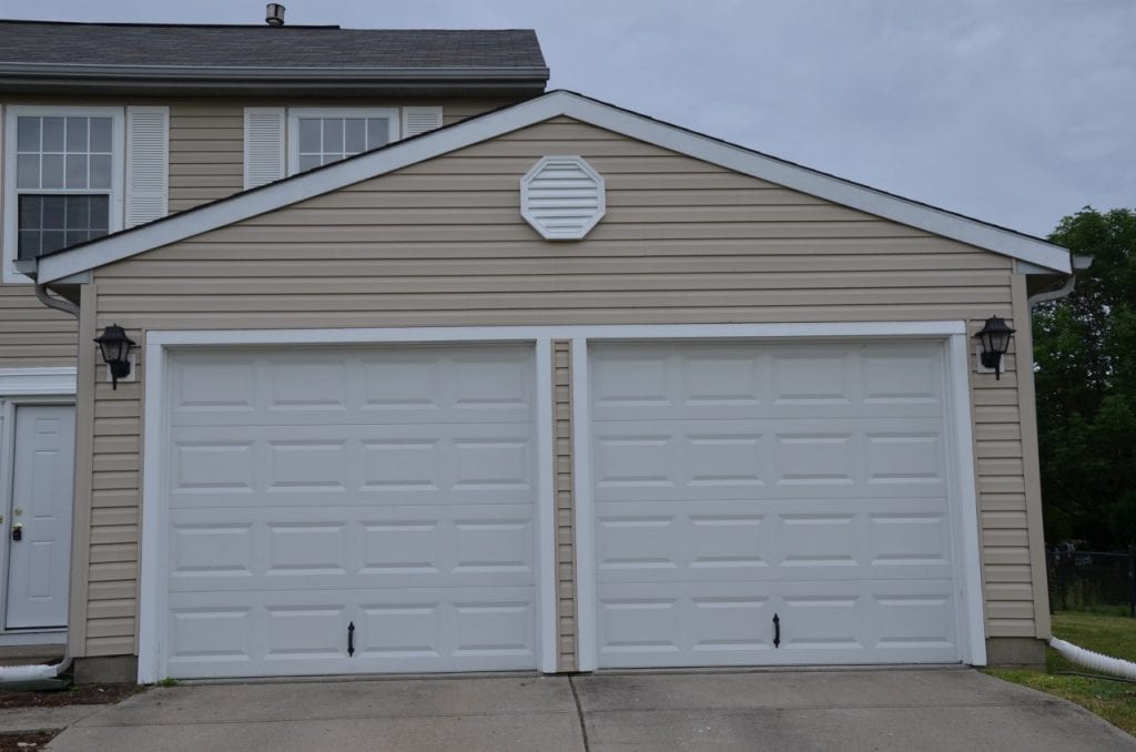 After: a garage exterior with repaired light fixtures