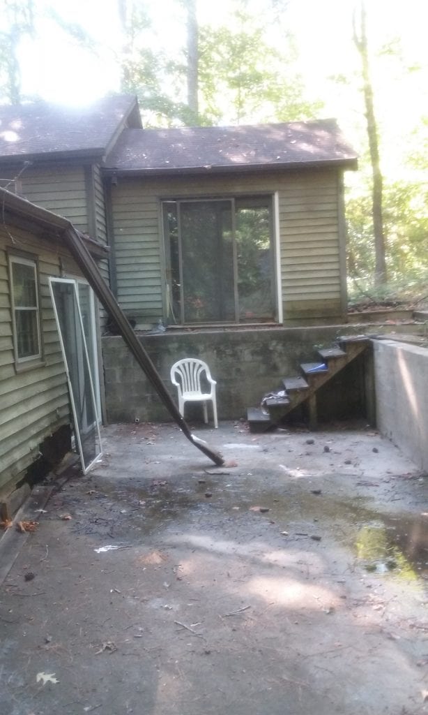 Before: a dilapidated back porch area
