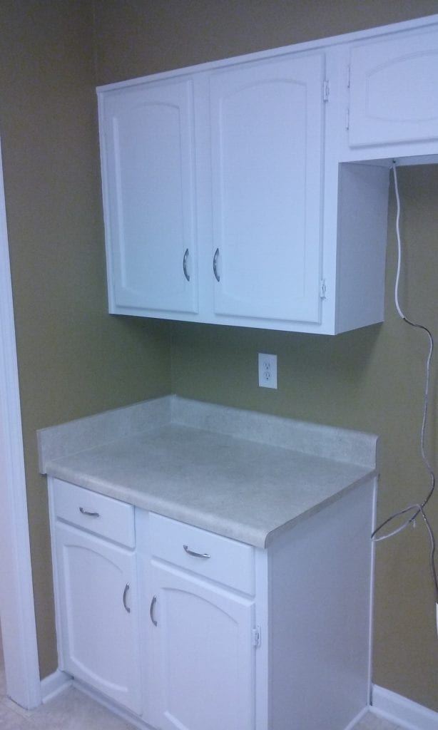 After: a modern kitchen renovation with fully-repaired and repainted cabinets