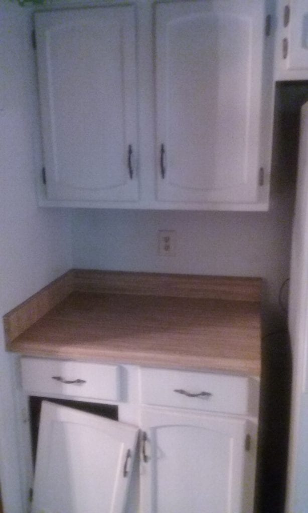 Before: an outdated kitchen with broken cabinets