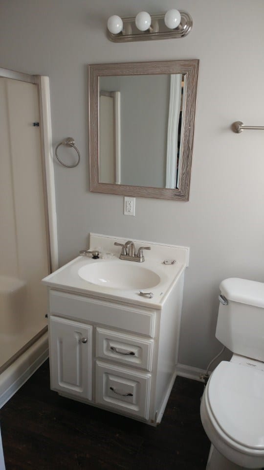 After: a mdoern bathroom with new fixtures and lighting