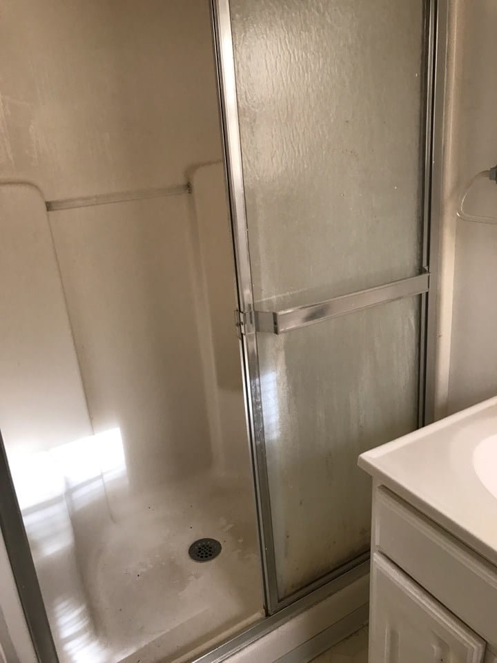 Before: a poorly-lit shower area