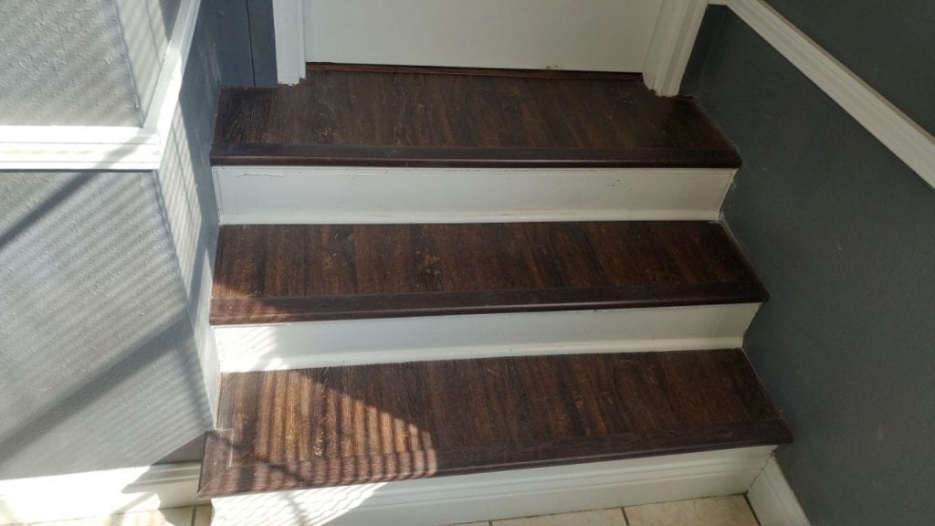 After: a modern interior stairway with new tile and wood flooring