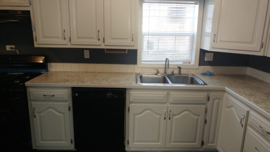 After: a modern-looking kitchen with new appliances and paint