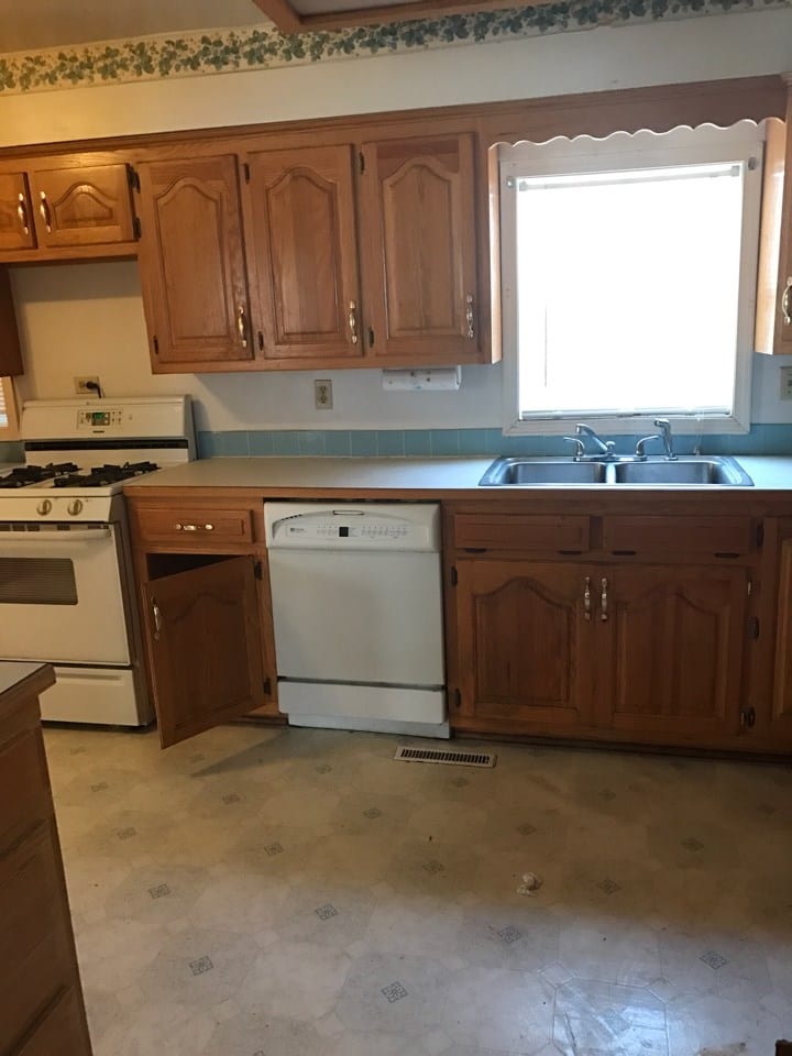 Before: an older kitchen with old appliances and fixtures