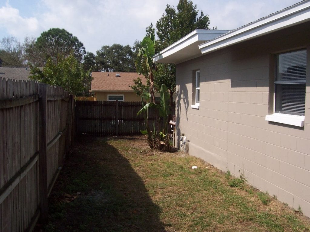 After: a house with new paint and a landscaped side yard